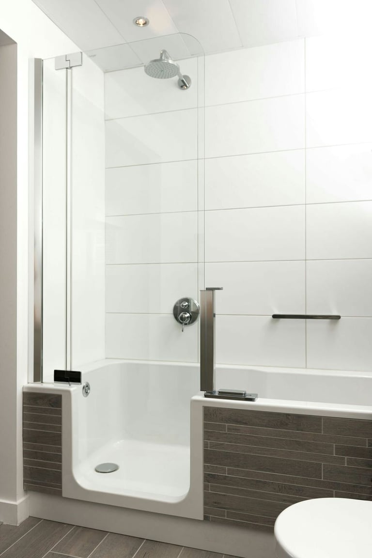 Modern bathroom with walk-in shower enclosure featuring glass doors, rainfall showerhead, and integrated bathtub with dark tile accent wall